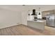 Open concept living and kitchen area with new floors and neutral paint at 5210 Poinsetta Ave, Winter Park, FL 32792