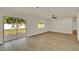 Living room with wood floors and view of backyard, complemented by natural light at 5210 Poinsetta Ave, Winter Park, FL 32792
