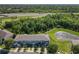 A beautiful aerial view of townhomes overlooking a serene pond next to the highway and lush green trees at 5420 Windsor Lake Cir, Sanford, FL 32773