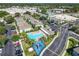 Aerial view of community pool, playground, parking area amid lush landscaping and buildings at 5420 Windsor Lake Cir, Sanford, FL 32773