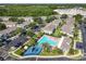 Aerial view of community pool, playground, parking area amid lush landscaping, surrounded by homes at 5420 Windsor Lake Cir, Sanford, FL 32773