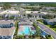 Aerial view of community pool, playground, parking area amid lush landscaping, highway in distance at 5420 Windsor Lake Cir, Sanford, FL 32773