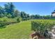 A backyard lush green lawn, and a black fence for extra privacy, under a clear blue sky at 5420 Windsor Lake Cir, Sanford, FL 32773