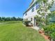 Backyard features a green lawn with an outdoor grill and a view of a black fence for extra privacy at 5420 Windsor Lake Cir, Sanford, FL 32773