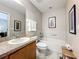 Neutral bathroom featuring a vanity with granite countertop, toilet, and a tub with tile surround at 5420 Windsor Lake Cir, Sanford, FL 32773