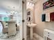 Charming powder room with pedestal sink and stylish accessories at 5420 Windsor Lake Cir, Sanford, FL 32773