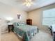 Cozy bedroom with a patterned quilt, a ceiling fan, and a neutral color scheme at 5420 Windsor Lake Cir, Sanford, FL 32773
