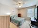Bedroom with a ceiling fan, artwork, window with blinds, and neutral colors at 5420 Windsor Lake Cir, Sanford, FL 32773