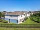 Exterior side view of a townhome with a well-manicured lawn and a black fence at 5420 Windsor Lake Cir, Sanford, FL 32773
