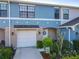 Townhome with attached garage, well-manicured flower beds, and covered porch for relaxing in comfort at 5420 Windsor Lake Cir, Sanford, FL 32773