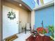 Cozy front porch featuring beautiful plants, flowers, and seating, creating a welcoming atmosphere at 5420 Windsor Lake Cir, Sanford, FL 32773