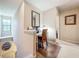 Home office space on landing with white desk, mirror, and natural light at 5420 Windsor Lake Cir, Sanford, FL 32773