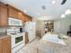 Spacious kitchen with a white appliance package, eat in dining, wooden cabinets, and tile flooring at 5420 Windsor Lake Cir, Sanford, FL 32773