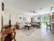 Spacious living room with neutral tones, tile floors, comfortable seating, and access to the backyard at 5420 Windsor Lake Cir, Sanford, FL 32773