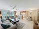 Open floor plan: living room flows into kitchen and dining area, perfect for modern living at 5420 Windsor Lake Cir, Sanford, FL 32773