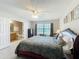 Spacious main bedroom with ensuite bathroom, featuring a decorative bed frame and dresser at 5420 Windsor Lake Cir, Sanford, FL 32773