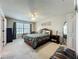Large main bedroom featuring a sitting area, decorative rug, and a neutral color scheme at 5420 Windsor Lake Cir, Sanford, FL 32773
