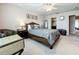 Well-lit main bedroom featuring a decorative bed, a comfortable sitting area, and access to a closet at 5420 Windsor Lake Cir, Sanford, FL 32773