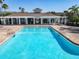 Bright blue community pool with lounge chairs under a clear sky at 5420 Windsor Lake Cir, Sanford, FL 32773