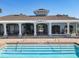 Community pool with a covered structure with pillars, providing shade and a relaxing space by the water at 5420 Windsor Lake Cir, Sanford, FL 32773