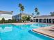 Community pool with lounge chairs and beautiful pergola, with surrounding townhomes at 5420 Windsor Lake Cir, Sanford, FL 32773