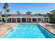 Sparkling community pool, featuring a pergola, with lounge chairs and beautiful palm trees at 5420 Windsor Lake Cir, Sanford, FL 32773