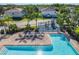 Community pool with playground, lounge chairs, clear blue water, and a manicured landscape at 5420 Windsor Lake Cir, Sanford, FL 32773