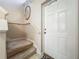 Inviting staircase leading to the upper level, located adjacent to the main entrance at 5420 Windsor Lake Cir, Sanford, FL 32773