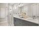 Contemporary bathroom featuring a glass-enclosed shower, dual sinks with sleek fixtures, and modern design elements at 570 Hammock Oaks Blvd, Lady Lake, FL 32159