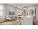 Well-designed kitchen island featuring pendant lighting, a dining area, and an open floor plan for modern living at 570 Hammock Oaks Blvd, Lady Lake, FL 32159