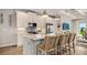 Modern kitchen featuring stainless steel appliances, a center island with seating, pendant lighting, and stylish backsplash at 570 Hammock Oaks Blvd, Lady Lake, FL 32159