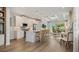 Open kitchen with an island, stainless appliances, and a view to the living area with large windows and bright light at 570 Hammock Oaks Blvd, Lady Lake, FL 32159