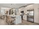Open-concept kitchen with a spacious island, modern appliances, light wood cabinets, and stylish pendant lights at 570 Hammock Oaks Blvd, Lady Lake, FL 32159