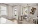 Bright living room with stylish seating, neutral decor, lots of natural light, and an adjacent kitchen area at 570 Hammock Oaks Blvd, Lady Lake, FL 32159