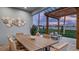 Relaxing outdoor patio with a dining area, comfortable seating, and a pergola for shade on sunny days at 570 Hammock Oaks Blvd, Lady Lake, FL 32159