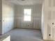 Bare bedroom with drywall ready for paint and one window for natural light at 5706 Cattle Ranch Drive, St Cloud, FL 34771