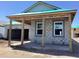 Exterior of a block construction home with a covered porch and windows framed in white at 5706 Cattle Ranch Drive, St Cloud, FL 34771