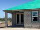 New home construction showcases concrete block walls, modern windows, a green roof, and an inviting entry at 5706 Cattle Ranch Drive, St Cloud, FL 34771