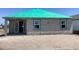 Newly constructed home with a green roof, featuring concrete block walls and modern windows at 5706 Cattle Ranch Drive, St Cloud, FL 34771