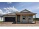 New home with an unfinished porch and an oversized garage at 5706 Cattle Ranch Drive, St Cloud, FL 34771