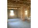 Unfinished interior with concrete block walls, exposed wood framing, and natural light streaming through windows at 5706 Cattle Ranch Drive, St Cloud, FL 34771