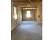 Unfinished interior space featuring concrete block walls, wood beams, and natural light from windows at 5706 Cattle Ranch Drive, St Cloud, FL 34771