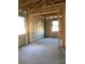 Spacious, unfinished interior featuring concrete block walls, exposed wood beams, and natural light at 5706 Cattle Ranch Drive, St Cloud, FL 34771