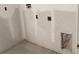 Bare laundry room with drywall ready for paint and utility hookups at 5706 Cattle Ranch Drive, St Cloud, FL 34771
