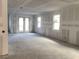 Spacious living room with drywall ready for paint and glass paneled patio doors at 5706 Cattle Ranch Drive, St Cloud, FL 34771