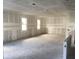 Large living room with ceiling grid and bare concrete floor at 5706 Cattle Ranch Drive, St Cloud, FL 34771