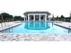 Stunning community swimming pool with crystal-clear water and paved deck surround at 5706 Cattle Ranch Drive, St Cloud, FL 34771