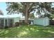 Private backyard featuring mature trees, a shed, and a chicken coop at 645 Peachwood Dr, Altamonte Springs, FL 32714