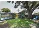 Lush backyard featuring a screened-in pool, large shade tree with swing, and privacy fence at 645 Peachwood Dr, Altamonte Springs, FL 32714