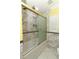 Bathroom showcasing the white tile surround and glass enclosed tub and shower at 645 Peachwood Dr, Altamonte Springs, FL 32714